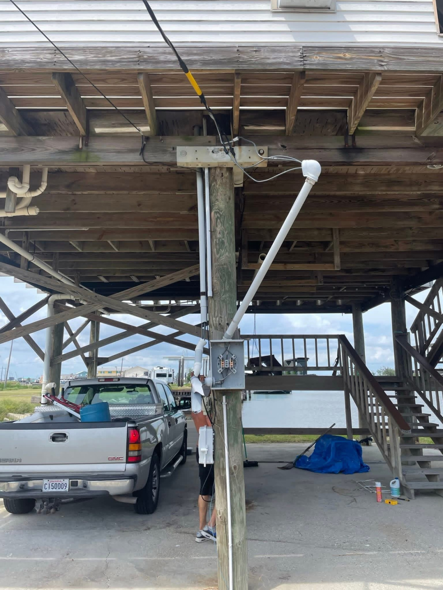 Electrical service mast and meter base on a raised camp