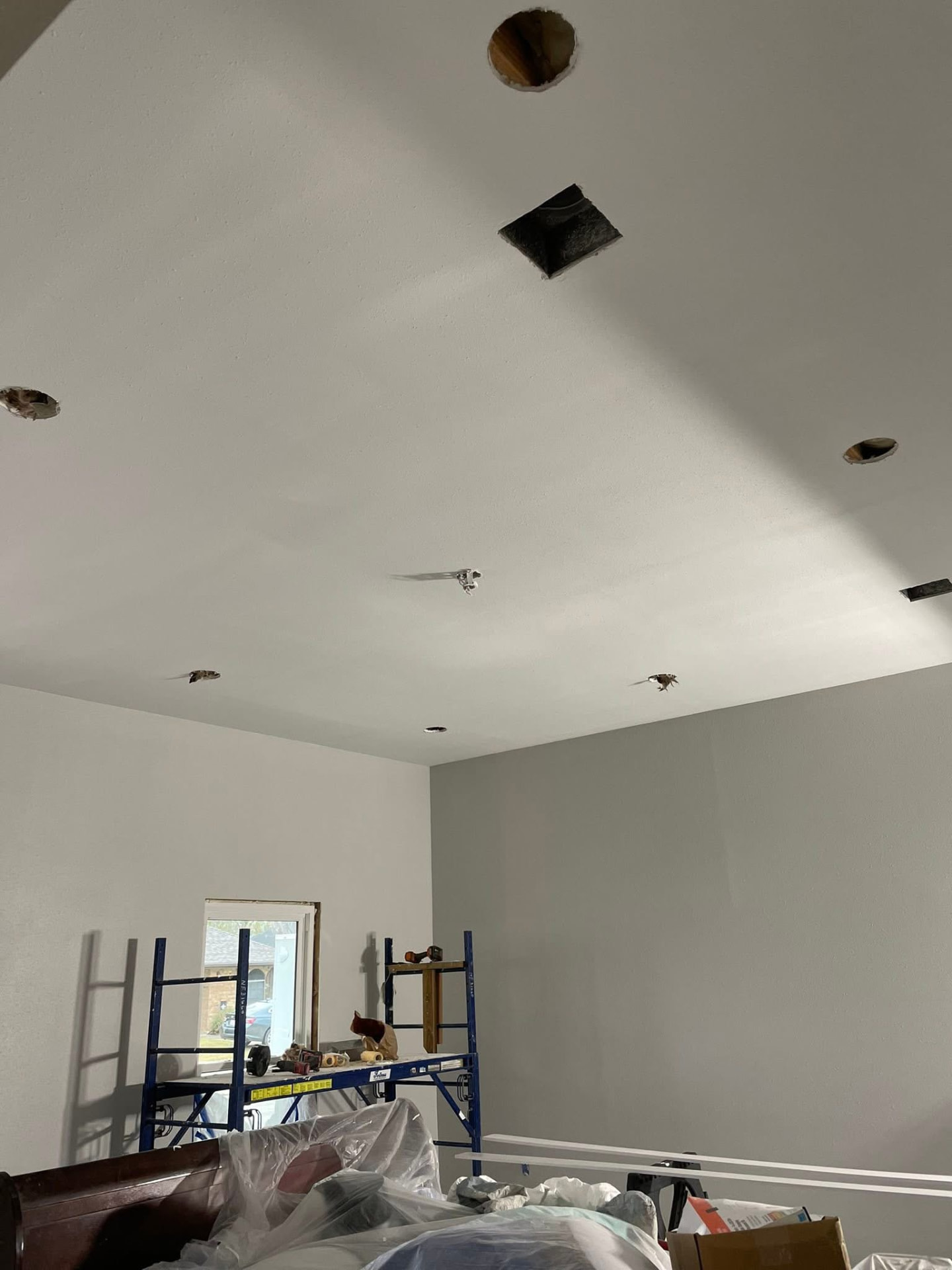Ceiling supply vents and can light rough-in during an HVAC and lighting job